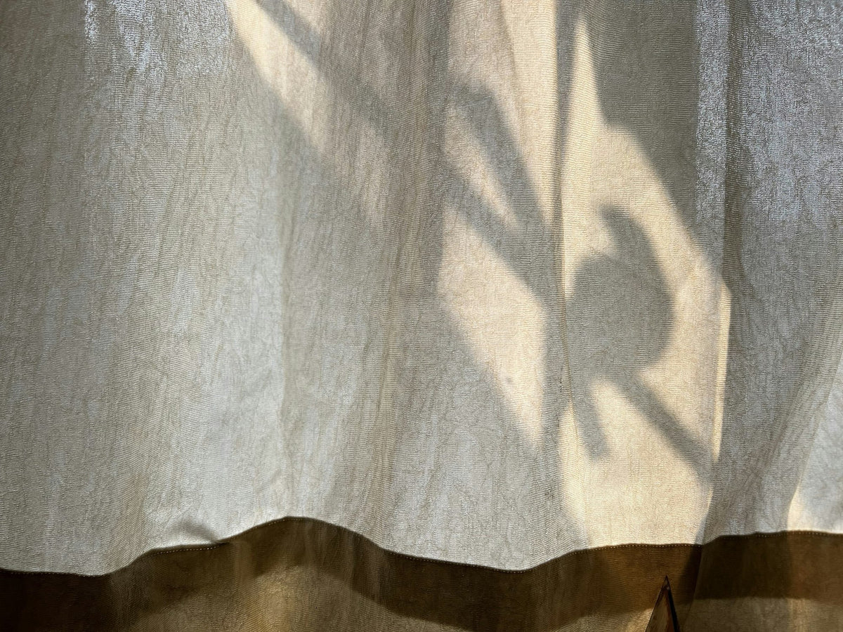 Linen curtain with the shadow of a plant